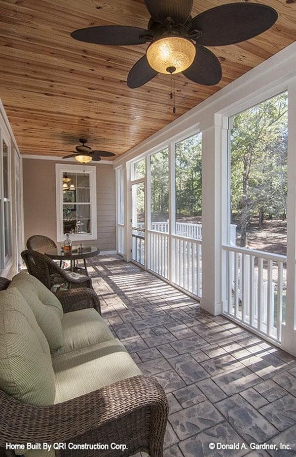 The screened porch is framed with white railings and decorative columns.