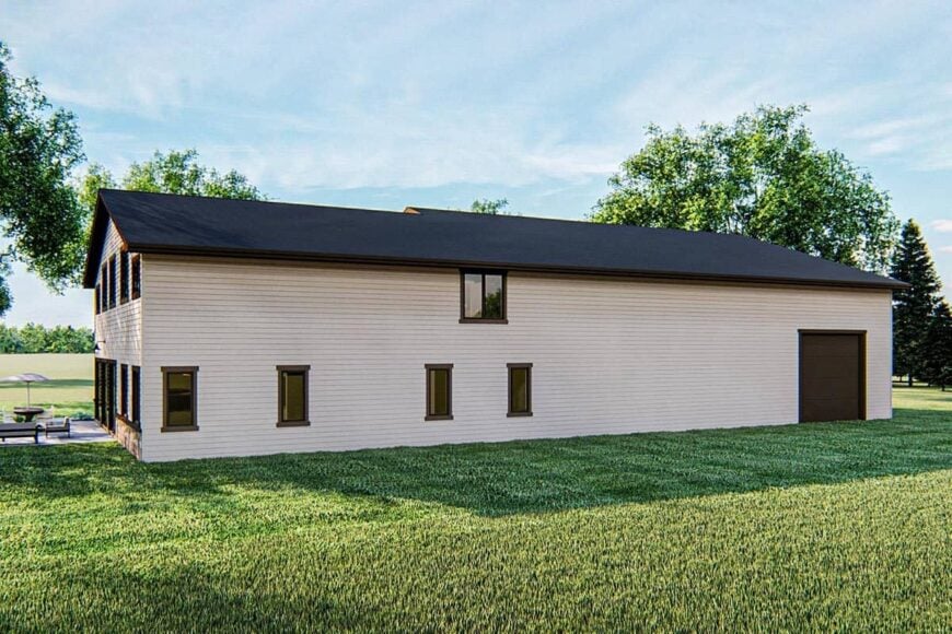 Home's rear view shows the glazed windows and black gable roof contrasted with cream exterior siding.