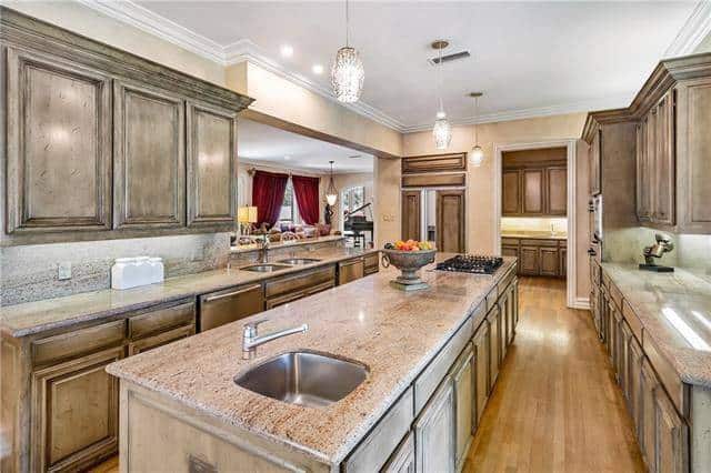 A closer look of the kitchen shows the undermount sinks and the butler's pantry on the side.