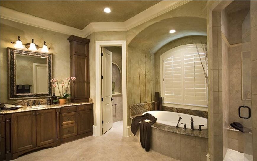 Primary bathroom with walk-in shower, a granite top sink vanity, and an alcove tub fixed under the white louvered window.