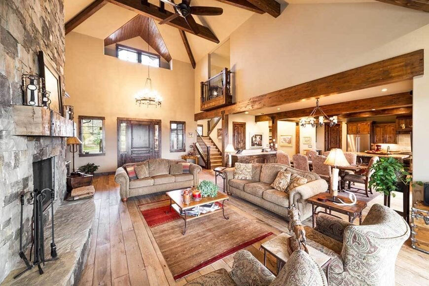 Behind the living room is the shared dining and kitchen defined with rustic wood trims.