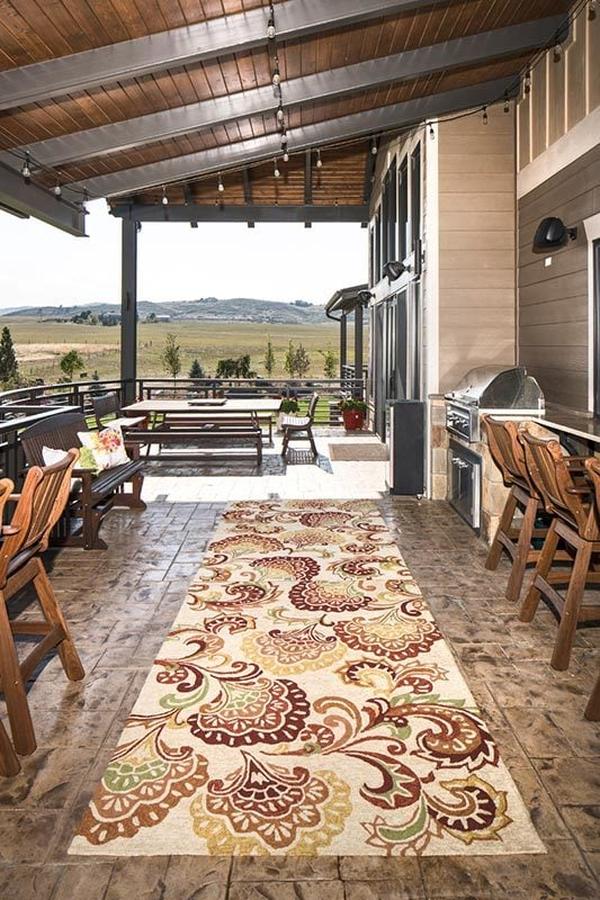 The covered deck consists of outdoor living and dining along with a summer kitchen.