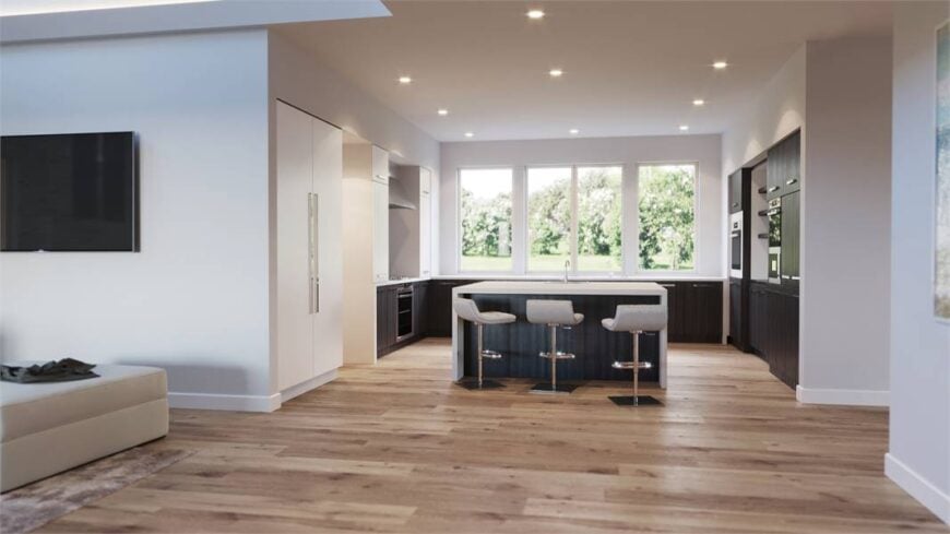 Kitchen with gray cabinetry, glass-paneled windows, and a center island paired with modern white bar stools.