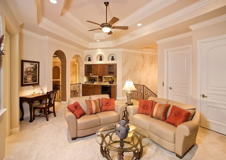 The opposite view shows the wet bar fixed under the arched inset shelves.
