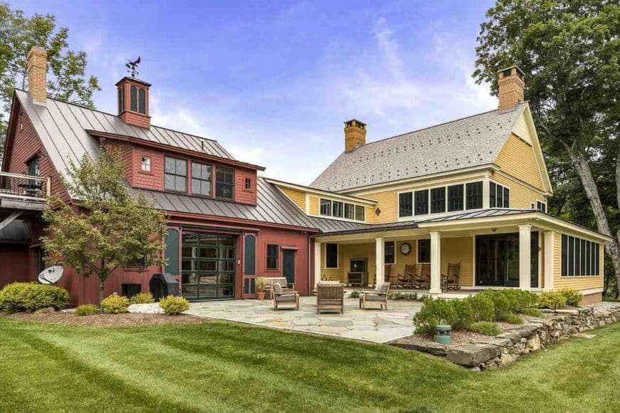 An L-shape that gives space for the terrace patio that has a stone mosaic ground surface that changes to the lush grass past enhanced with bushes and trees.