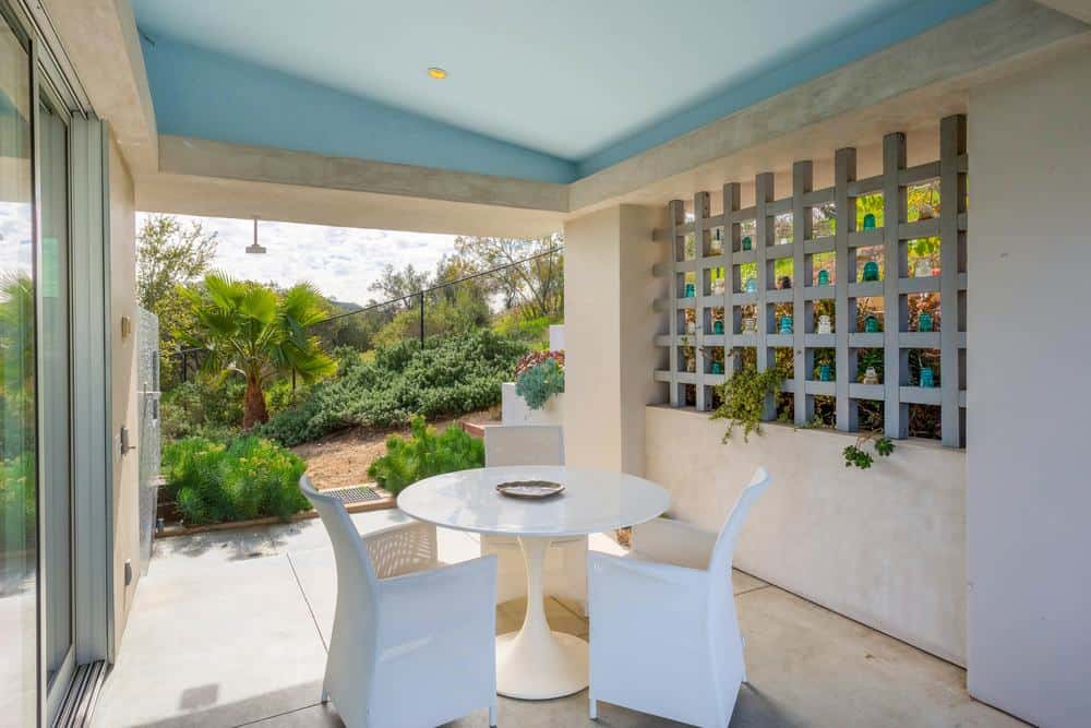 This is the lovely patio fitted with an intimate outdoor dining set. This is complemented by the concrete floor that transitions to the garden landscaping just a few steps away.