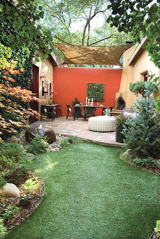 This patio features a dining space imitates a customary indoor space, packed with sconces on the plaster divider, flanking an enormous brightening mirror.