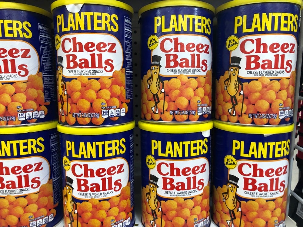 Planters Cheez balls on display on a grocery shelf.