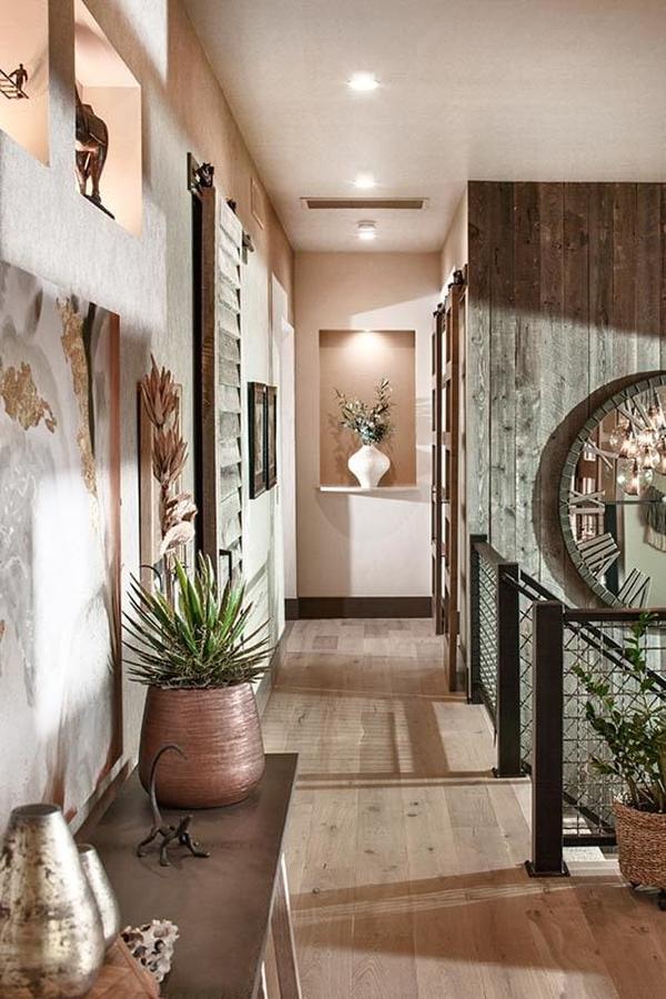 Hallway with natural hardwood flooring and an inset wall occupied by a white flower vase.