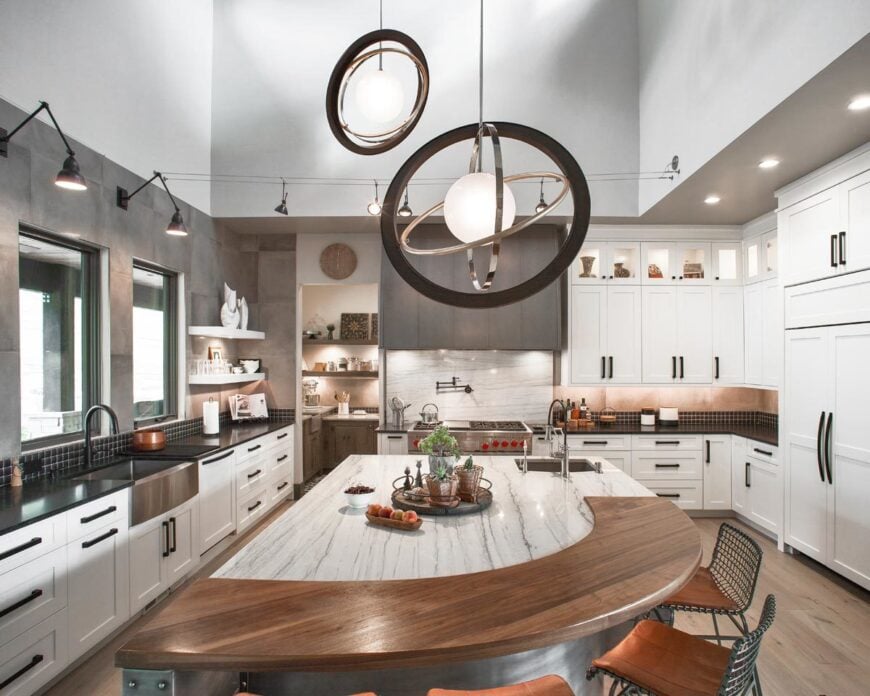There's also a farmhouse sink that blends in with the black granite countertops.