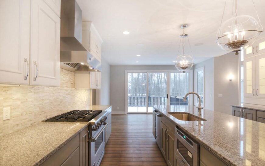 The kitchen offers lots of counter space, stainless steel appliances, and an undermount sink fitted on the central island.