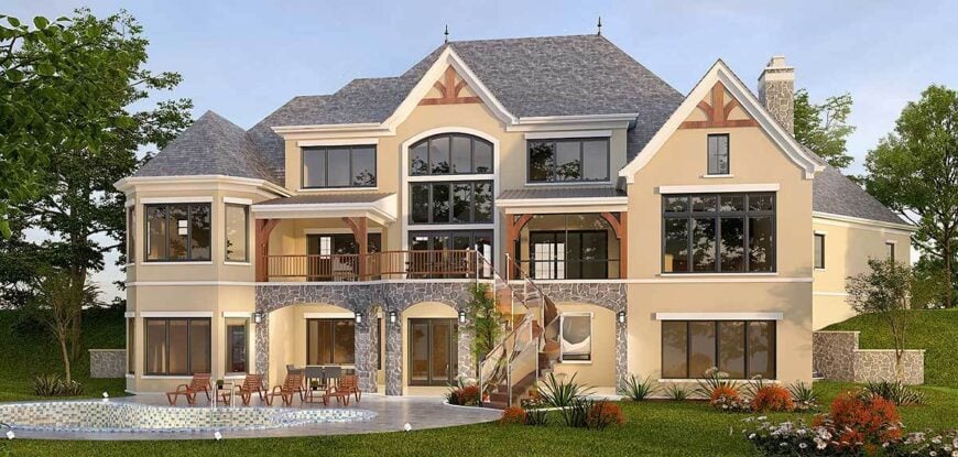 The rear exterior view shows the tinted glass windows, covered balconies, and a lower veranda framed with stone columns.