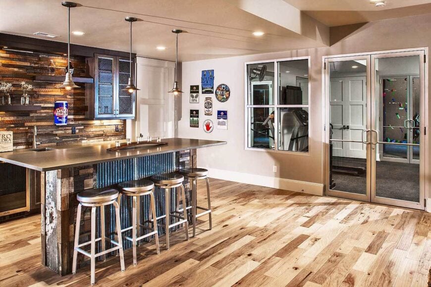 Wet bar with rustic islands and dark wood floating shelves fixed against the wood-paneled backsplash.