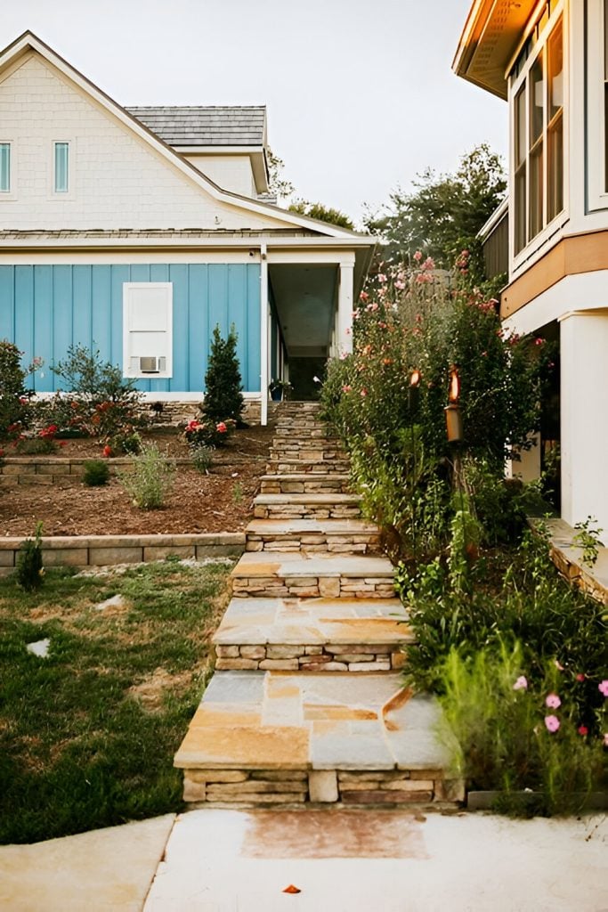 There's a flagstone pathway on the side that's accented with stone risers.