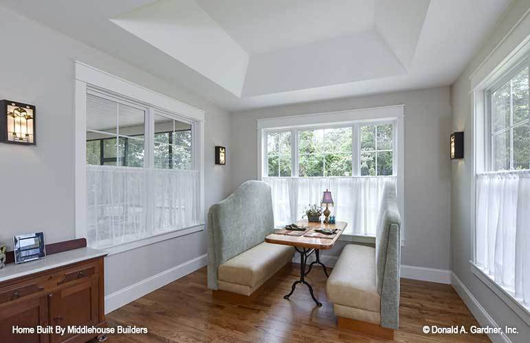 The dining room offers a wooden buffet bar, rectangular dining table, and comfy upholstered benches.
