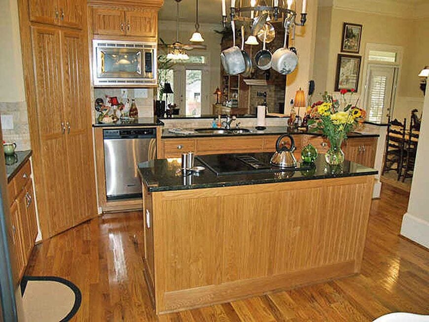 There are also stainless steel appliances and custom wood cabinets that blend in with the hardwood flooring.