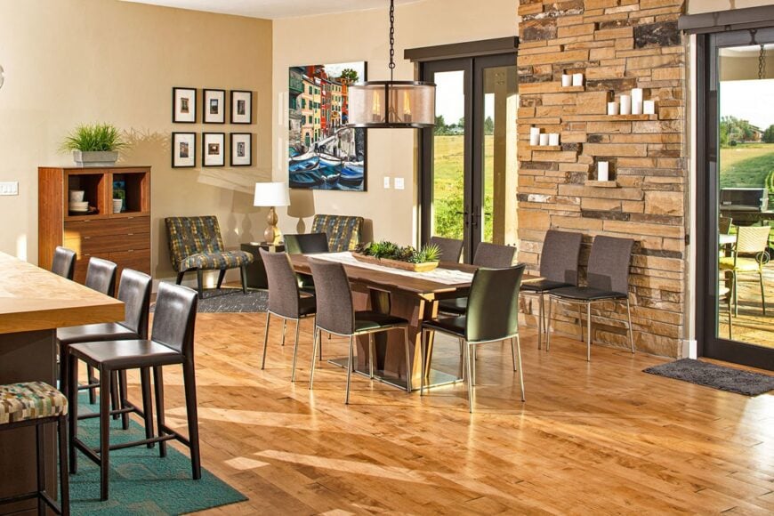 The dining area offers plenty of chairs and a wooden dining table well lit by a drum chandelier.