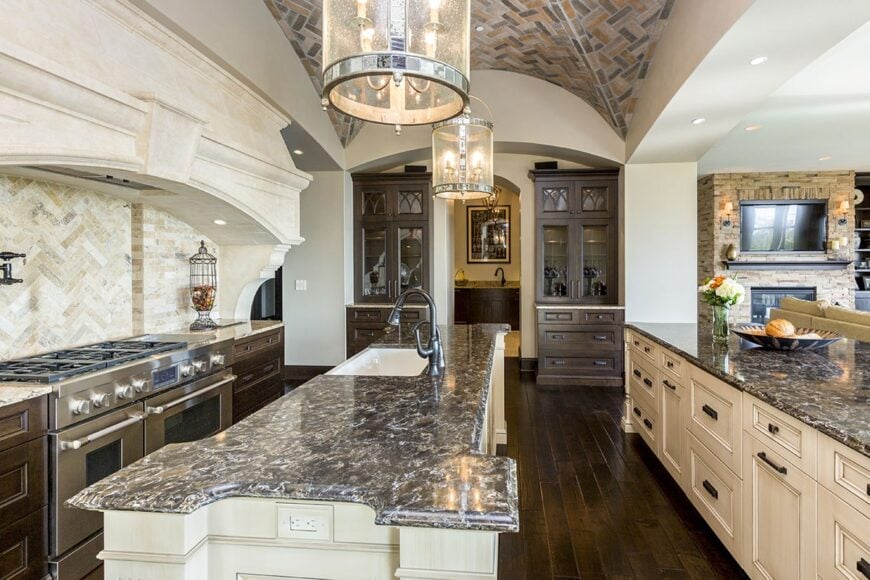 Another look at the kitchen showcasing the breakfast bar and the center island fitted with an undermount sink.