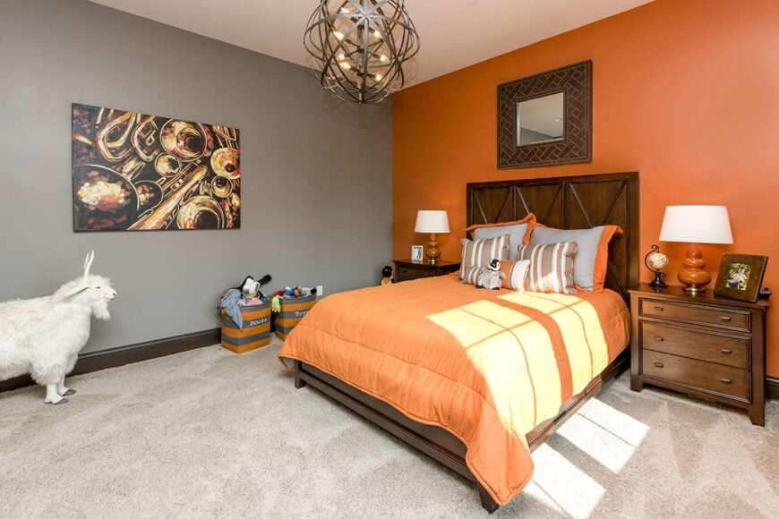 Another bedroom with dual-tone walls and a white regular ceiling mounted with a stylish wrought iron chandelier.
