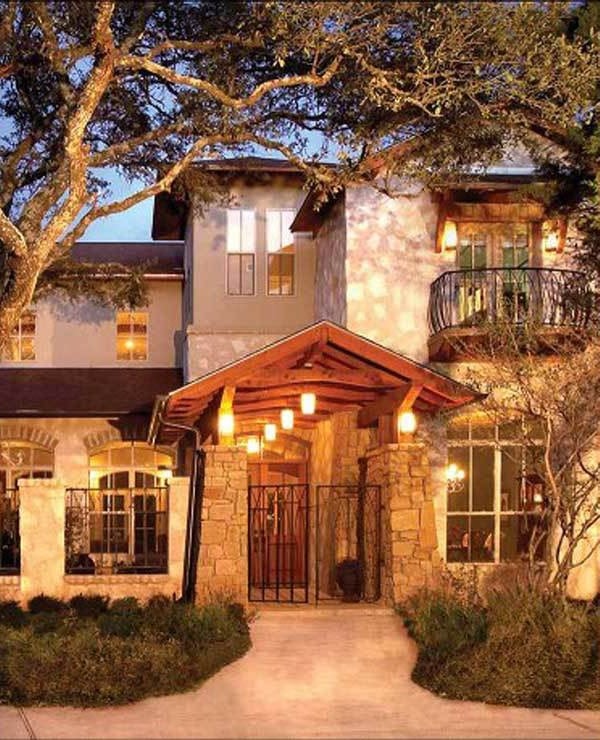 Home entry with a beamed cathedral ceiling supported by large stone columns.