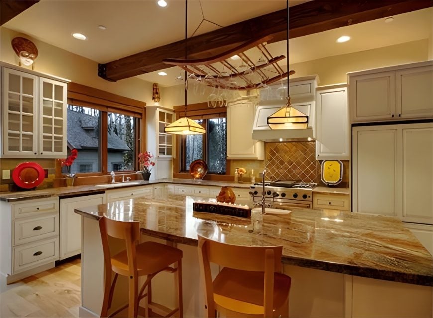 The kitchen is equipped with white cabinetry, granite countertops, hanging wine glass rack, and a center island paired with cushioned bar chairs.