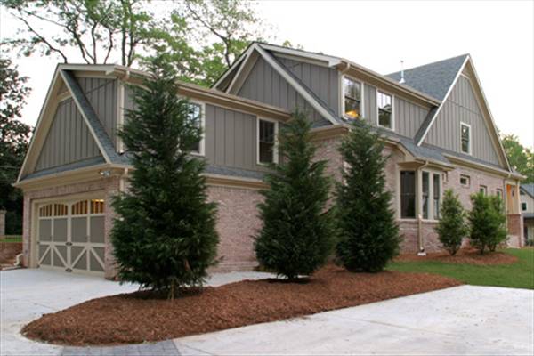 Angled rear view showing the two-car garage complemented with a concrete driveway.