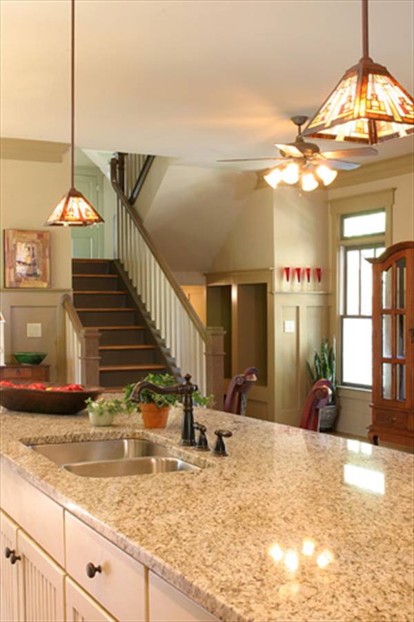 The staircase leading to the sleeping areas sits adjacent to the kitchen.