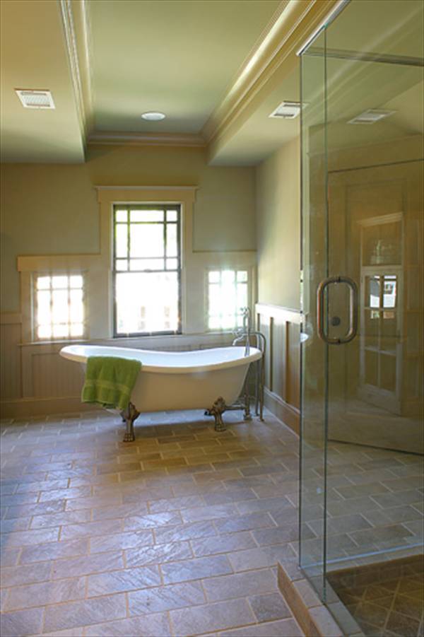 Primary bathroom with a walk-in shower and a clawfoot tub placed against the Palladian window.