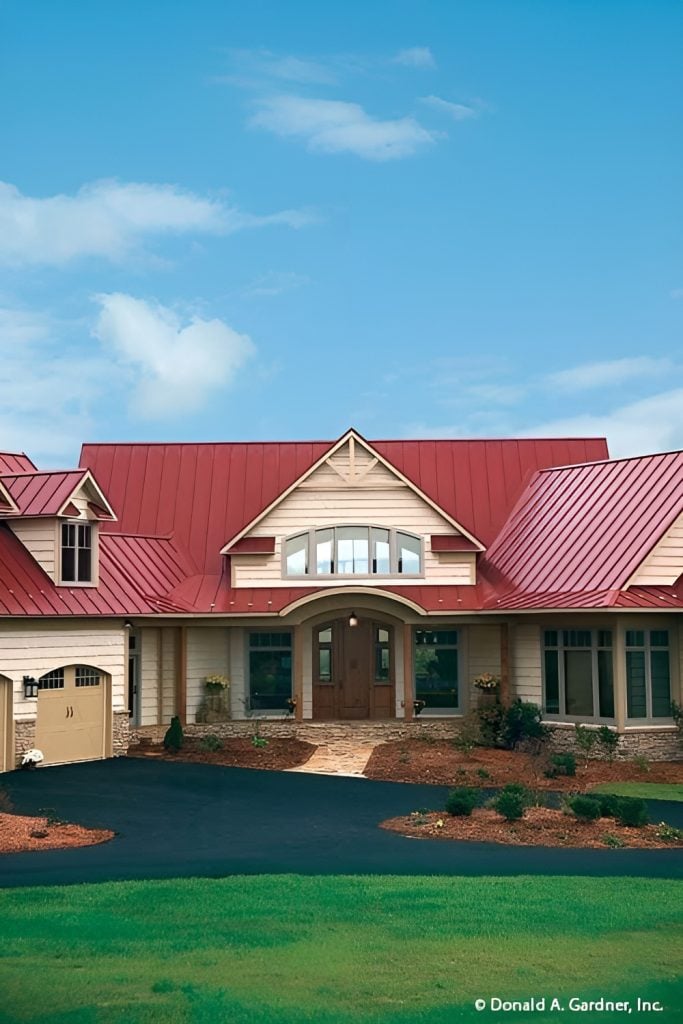 Home facade with a wrapped around porch and a courtyard entry garage adorned with charming dormers.