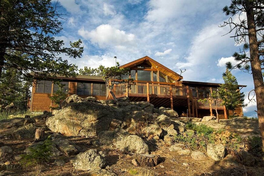 Rear exterior view with a large open deck and a multitude of glass windows.