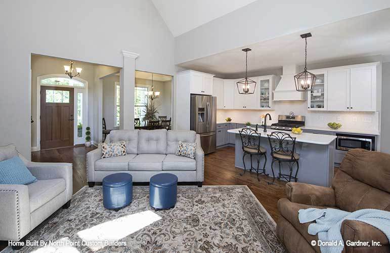 An open layout view showing the foyer, living room, dining area, and the kitchen.