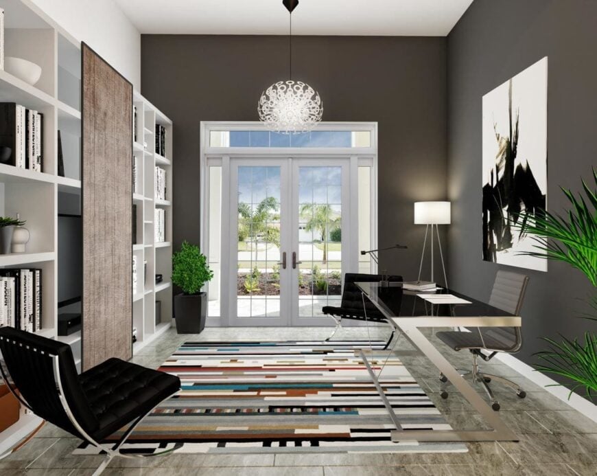 Study with white built-ins, modern furnishings, and a french door that opens out to the front porch.