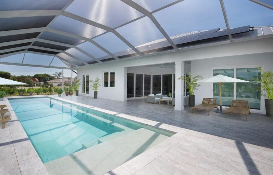 Spacious lanai with multiple seating and a swimming pool topped with a retractable roof.Spacious lanai with multiple seating and a swimming pool topped with a retractable roof.