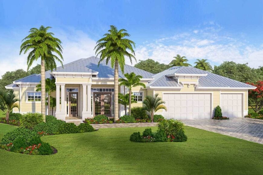 The home is graced with towering palm trees, manicured shrubs, and a green lush lawn.