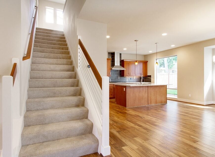 A traditional staircase covered in a beige carpet brings you to the sleeping quarters.