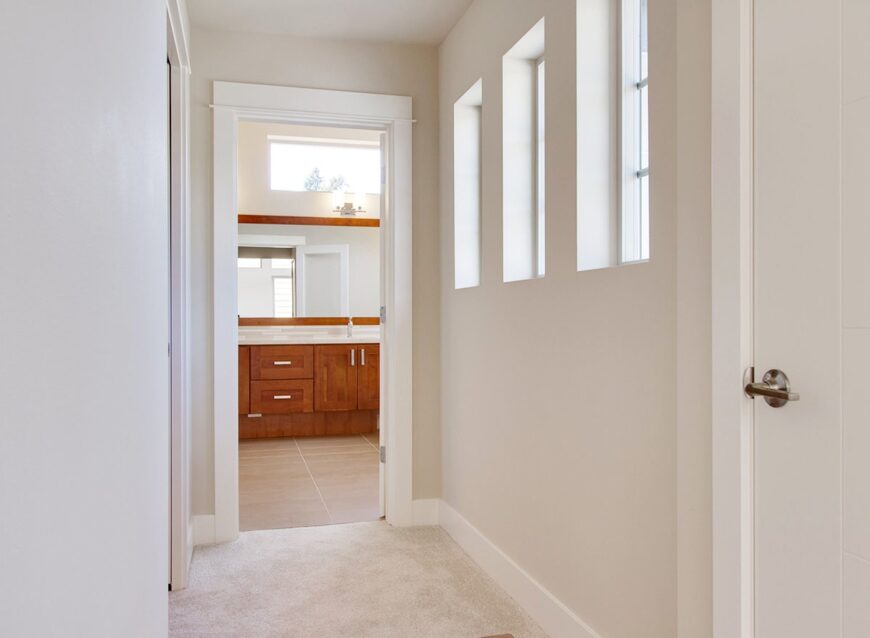 This hallway leads to the walk-in closet on the side and the primary bathroom ahead.