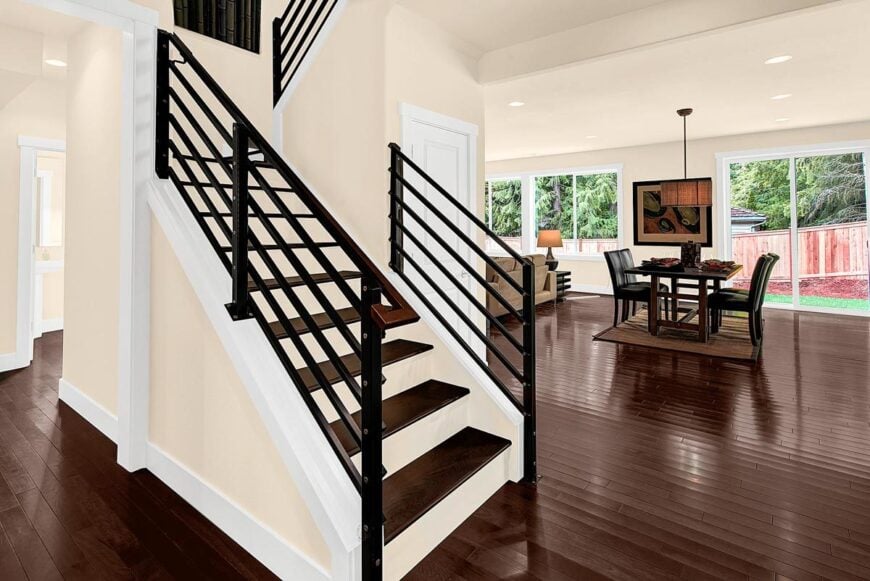 Traditional staircase with closet storage on the side enclosed in a white door.