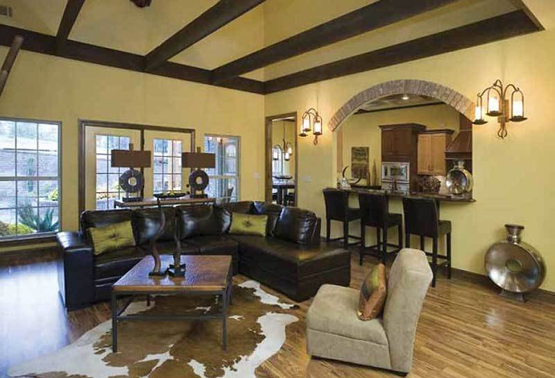 Sitting next to the living room is a bar with an arched window and black counter chairs.