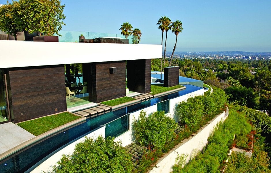 This is an aerial view of the house that showcases the moat surrounding the house that gives it an island-style look. You can also see here the sweeping views of the city below.