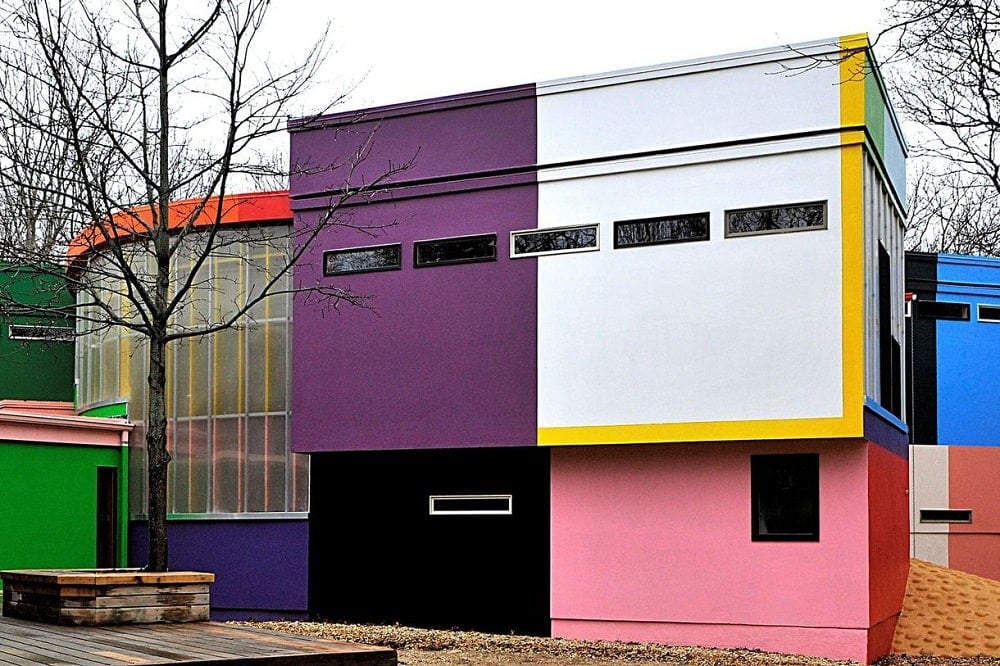 This closer look at the front of the house shows a large frosted glass wall that stands out against the vibrants different colors of the exterior walls. Image courtesy of Toptenrealestatedeals.com.