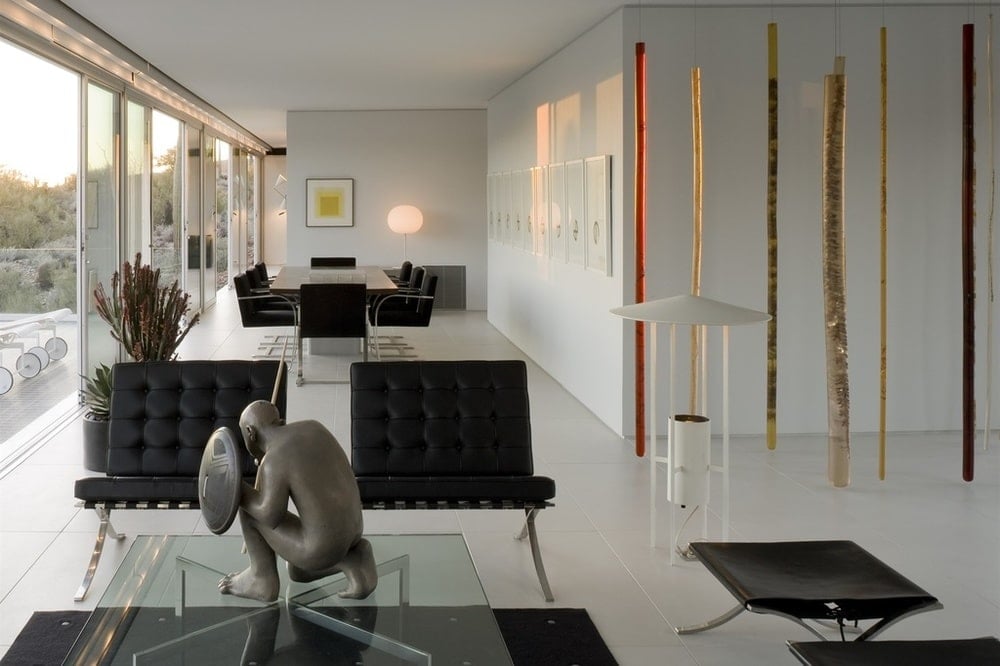 This is a look at the dining area from the vantage of the living room area. It has black modern furniture to match the aesthetic of the living room. Image courtesy of Toptenrealestatedeals.com.