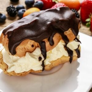A piece of chocolate eclair cake garnished with fresh fruits.