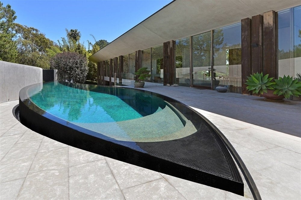 Focused look at the home's custom swimming pool that looks absolutely stunning.