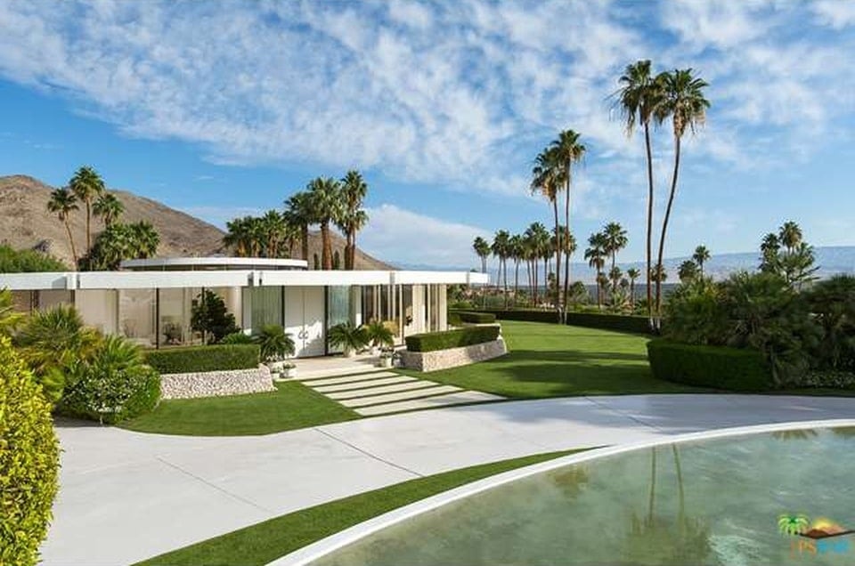 This is a front view of the house from the vantage of the street. You can see here the wide walkway with concrete slabs on the grass lawn leading to the main entrance. Image courtesy of Toptenrealestatedeals.com.
