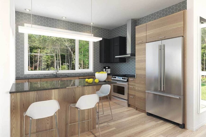 The kitchen is equipped with stainless steel appliances, wooden cabinetry, a peninsula, and black overhang cabinets fixed against the hex tile backsplash.