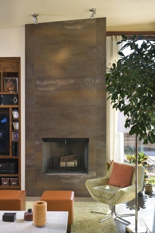 Chrome track lights illuminate the stone fireplace that's complemented with a sleek armchair.