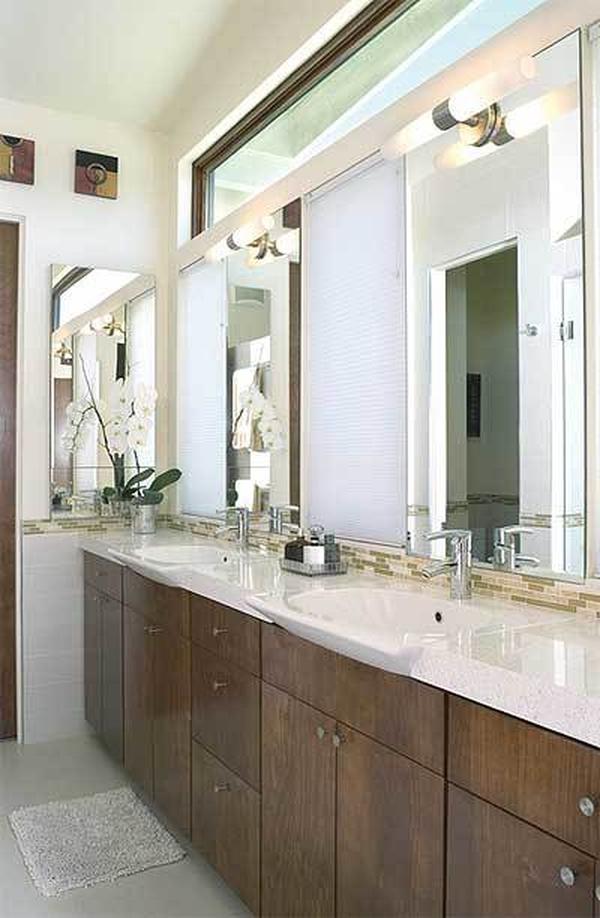 The primary bath features a dark wood vanity with two porcelain sinks and a white granite countertop.