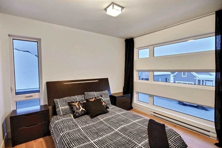 This bedroom has glazed walls and a dark wood bed flanked with matching nightstands.