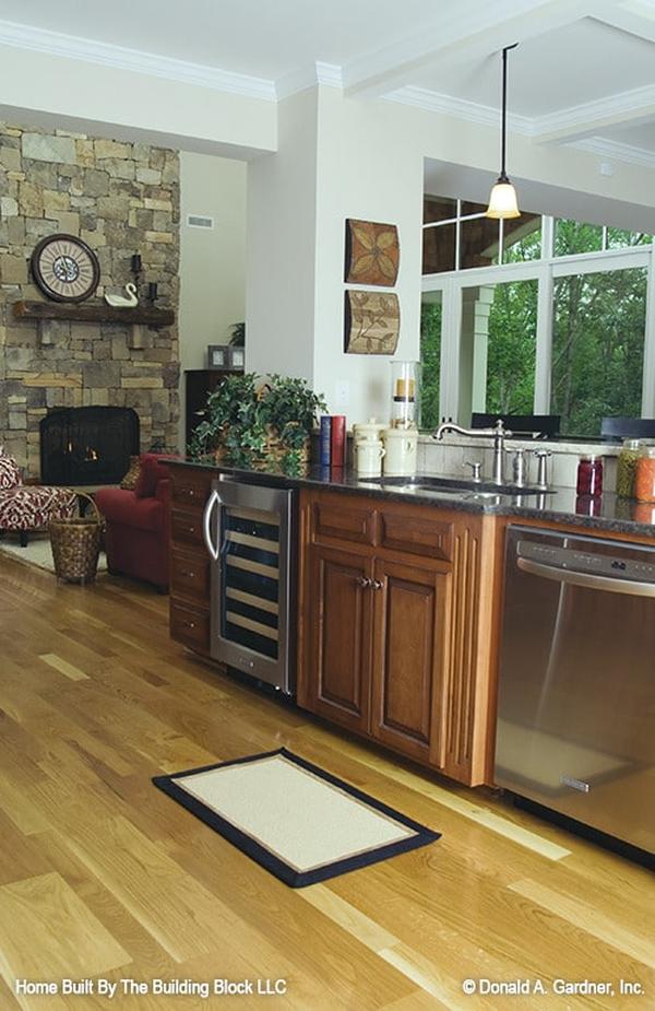 Built-in dishwasher and wine fridge fitted on the two-tier peninsula complete the kitchen.