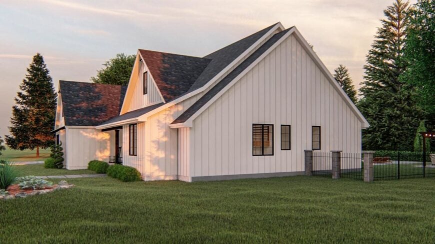 Right side view showcasing the white vertical exterior siding that stands out against the lush green lawn.